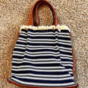 Boho purse with navy and white woven sides and leather bottom and straps
